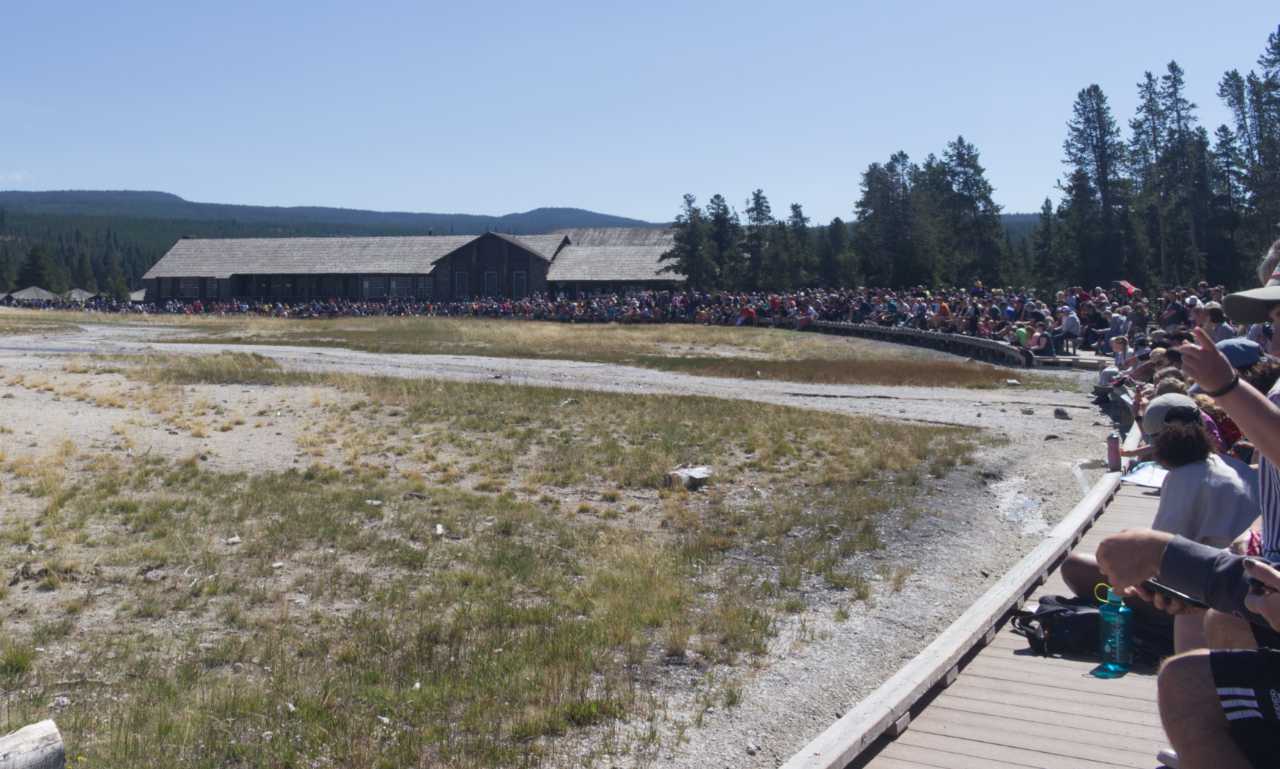 A large crowd in Yellowstone National Park waiting for Old Faithful to erupt